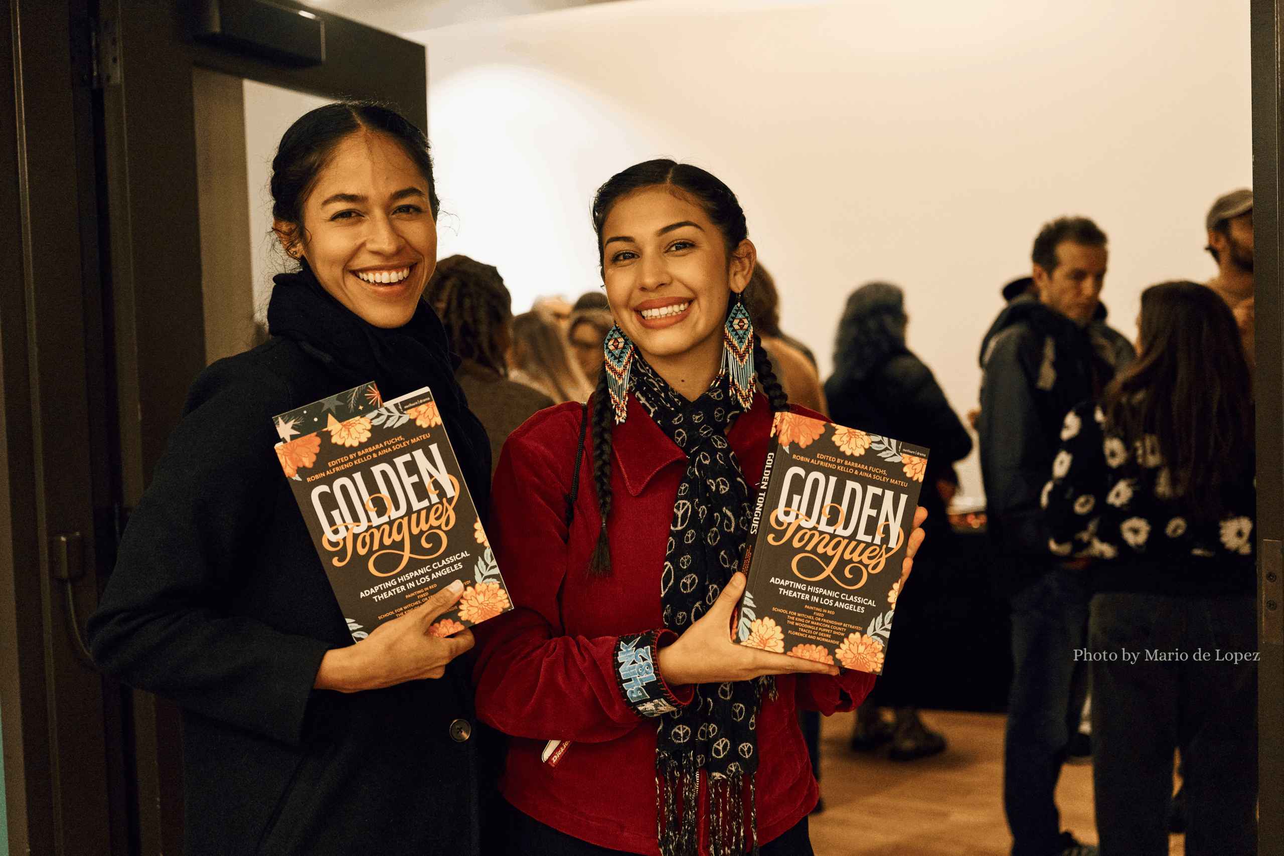 Two women holding books entitled "Golden Tongues"