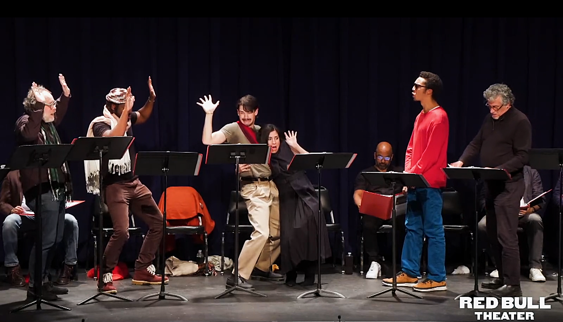 Actors looking scared during a staged reading