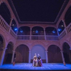 Two actors on stage and looking out into the audience