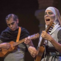 Image of two actors on stage playing guitar.