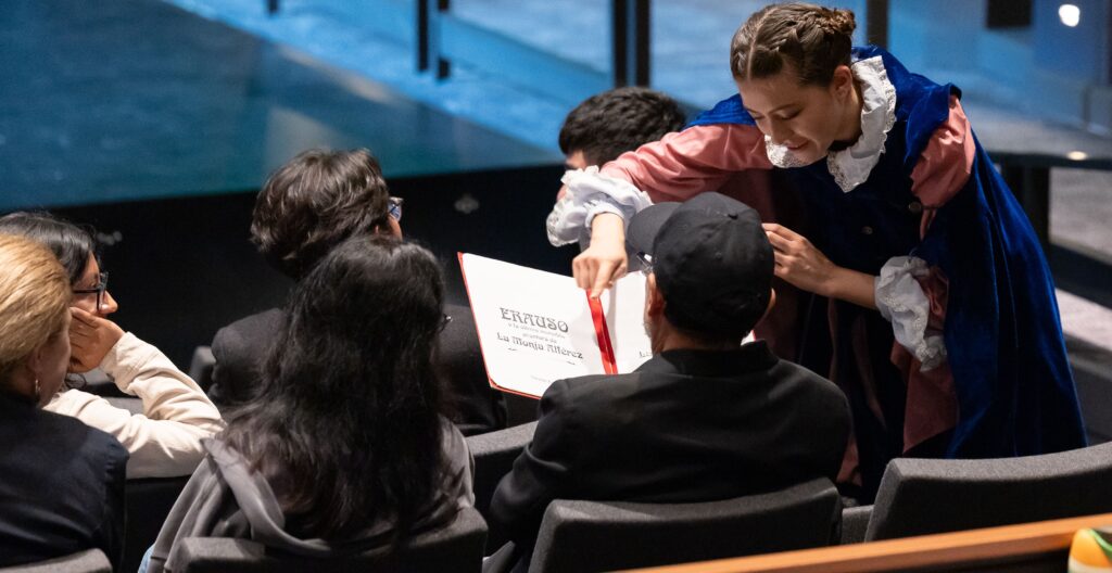 Actress with binder in her hands and showing it to an audience members