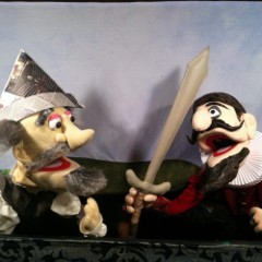 Two puppets with one carrying a sword