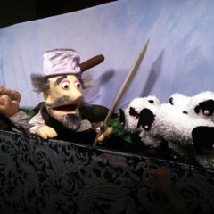 A puppet holding a sword and looking at sheep