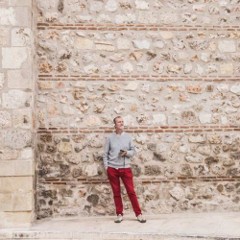 Image of someone against a stone wall. 