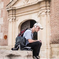 Image of a person sitting down with headphones on