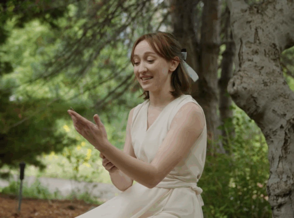 A woman happily looking at her hand