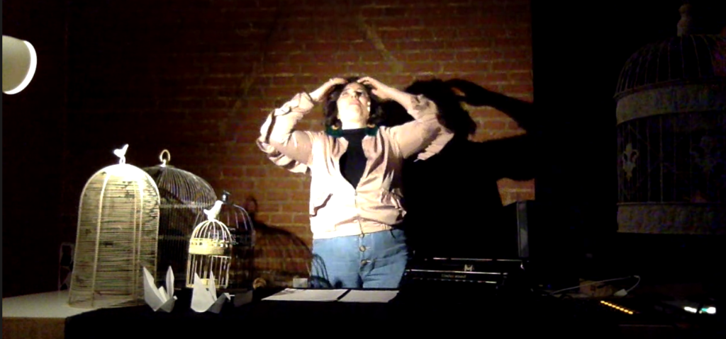 actor clutching their own head onstage